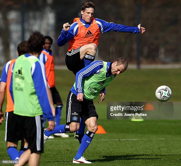 Marcell Jansen and David Rozehnal of Hamburg compete for the ball during the Hamburger SV training session at the HSH Nordbank Arena on March 25,...