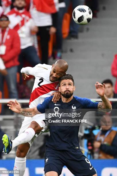 Peru's defender Alberto Rodriguez heads the ball as he vies for it with France's forward Olivier Giroud during the Russia 2018 World Cup Group C...