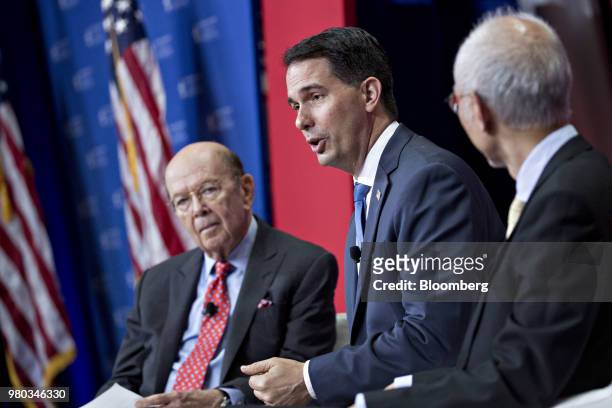 Scott Walker, governor of Wisconsin, center, speaks as Louis Woo, special assistant to the chairman and chief executive officer of Foxconn Technology...