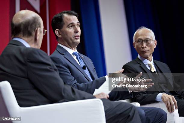 Scott Walker, governor of Wisconsin, center, speaks as Louis Woo, special assistant to the chairman and chief executive officer of Foxconn Technology...