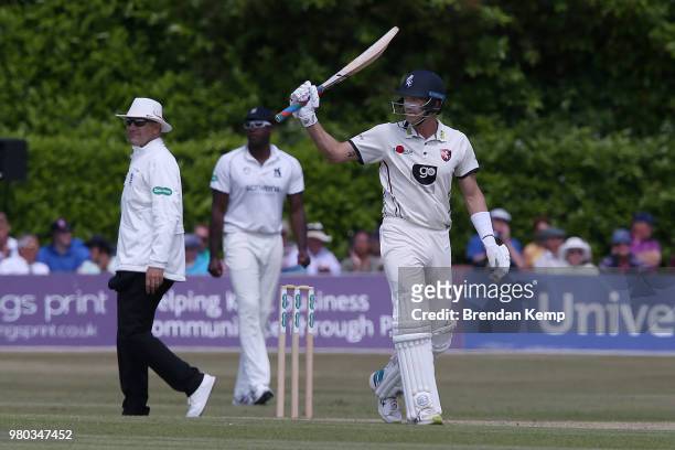 Joe Denly of Kent celebrates reaching 50 runs on day two of the Specsavers County Championship: Division Two match between Kent and Warwickshire at...