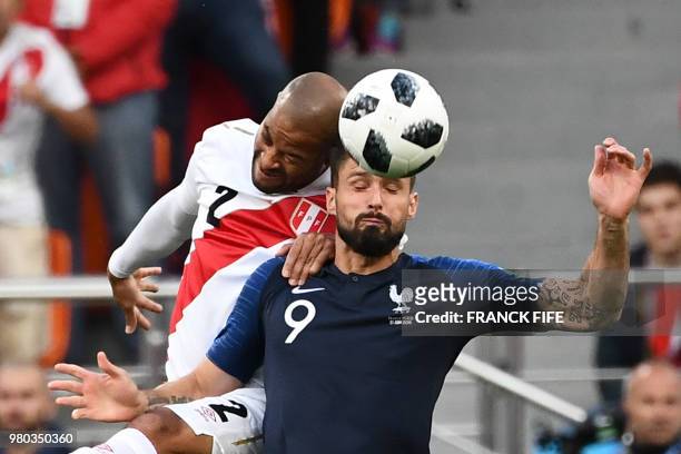 Peru's defender Alberto Rodriguez heads the ball as he vies for it with France's forward Olivier Giroud during the Russia 2018 World Cup Group C...