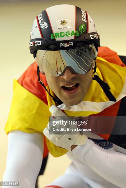 Robert Forstemann of Germany carries the Germany flag after winning Men's Team Sprint on Day One of the UCI Track Cycling World Championships at the...