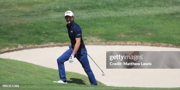Sebastien Gros of France walks out of a bunker on the 11th hole during day one of the BMW International Open at Golf Club Gut Larchenhof on June 21,...