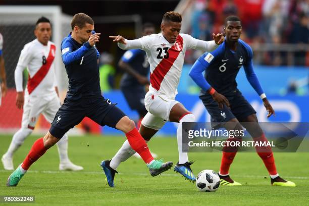 France's forward Antoine Griezmann and Peru's midfielder Pedro Aquino compete for the ball during the Russia 2018 World Cup Group C football match...