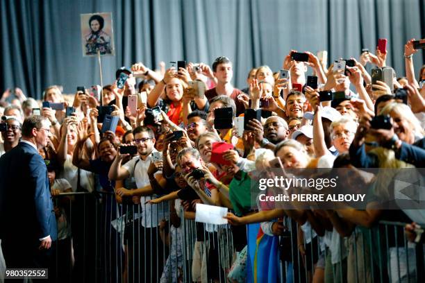 People take picture of Pope Francis as he celebrates a mass during his one-day visit at the invitation of the World Council of Churches on June 21,...