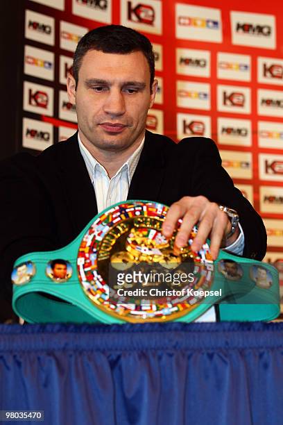 Vitali Klitschko of Ukraine position his winning belt during the conference at Veltins Arena on March 25, 2010 in Gelsenkirchen, Germany. The WBC...