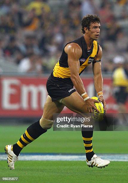 Troy Simmonds of the Tigers in action during the round one AFL match between the Richmond Tigers and Carlton Blues at the Melbourne Cricket Ground on...