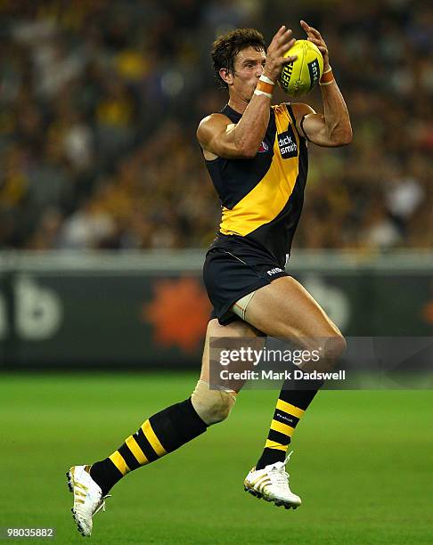 Troy Simmonds of the Tigers gathers the ball during the round one AFL match between the Richmond Tigers and Carlton Blues at Melbourne Cricket Ground...