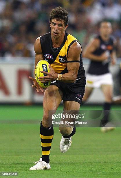 Troy Simmonds of the Tigers in action during the round one AFL match between the Richmond Tigers and Carlton Blues at the Melbourne Cricket Ground on...