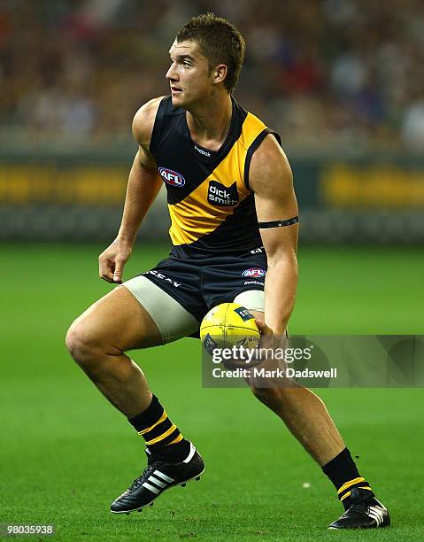 Dustin Martin of the Tigers looks for a teammate during the round one AFL match between the Richmond Tigers and Carlton Blues at Melbourne Cricket...