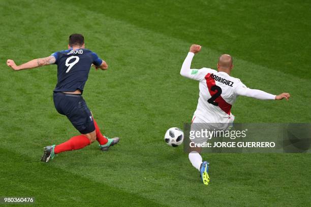 Peru's defender Alberto Rodriguez tries to block a shot from France's forward Olivier Giroud during the Russia 2018 World Cup Group C football match...