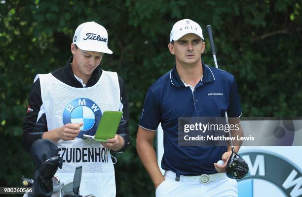 Christiaan Bezuidenhout of South Africa looks on with his caddie during day one of the BMW International Open at Golf Club Gut Larchenhof on June 21,...