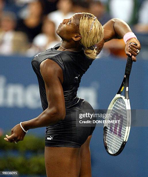 Number one seeded Serena Williams of the US serves to Corina Morariu of the US during first round action at the US Open Tennis tournament 26 August,...