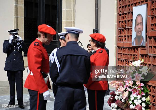 French policeman takes photographs of fellow police members and Basque regional police members during a homage to Serge Nerin , at the Basque...