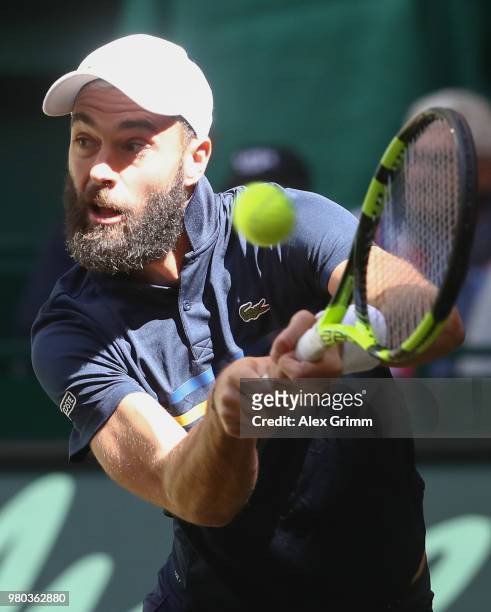 Benoit Paire of France plays a backhand volley to Roger Federer of Switzerland during their round of 16 match on day 4 of the Gerry Weber Open at...