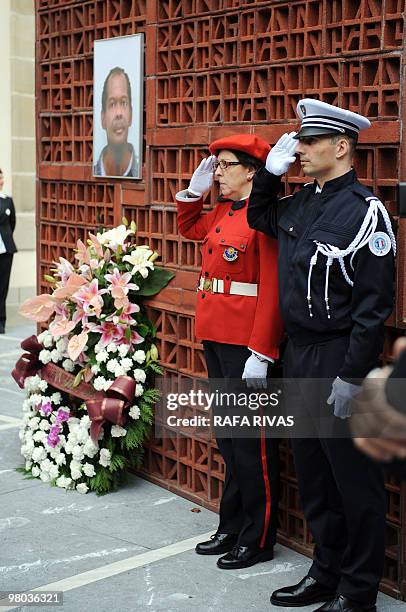 French and Basque regional police members salute during an hommage to Serge Nerin at the Basque regional parliament in Vitoria, northern Spain, on...