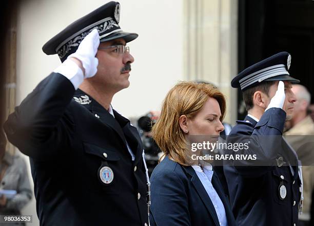Basque Parliament president Arancha Quiroga , flanked by two saluting French police members, pay homage to Serge Nerin at the Basque regional...