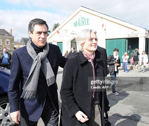 French Prime Minister Francois Fillon and member of leading right-wing party UMP and his wife Penelope leave the polling station after voting in...