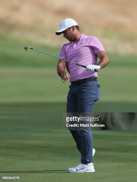 Jason Day of Australia watches his tee shot on the 12th hole during the first round of the Travelers Championship at TPC River Highlands on June 21,...