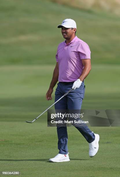 Jason Day of Australia watches his tee shot on the 12th hole during the first round of the Travelers Championship at TPC River Highlands on June 21,...
