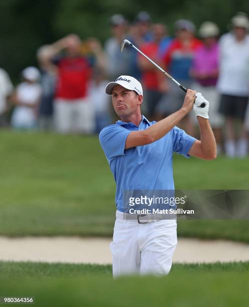 Webb Simpson watches his second shot on the 12th hole during the first round of the Travelers Championship at TPC River Highlands on June 21, 2018 in...