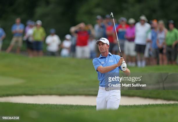 Webb Simpson watches his second shot on the 12th hole during the first round of the Travelers Championship at TPC River Highlands on June 21, 2018 in...