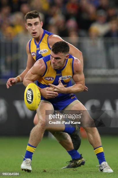 Luke Shuey of the Eagles fumbles the ball during the round 14 AFL match between the West Coast Eagles and the Essendon Bombers at Optus Stadium on...