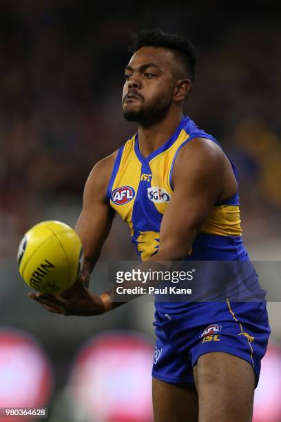 Willie Rioli of the Eagles handballs during the round 14 AFL match between the West Coast Eagles and the Essendon Bombers at Optus Stadium on June...