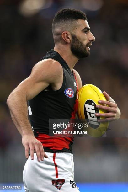 Adam Saad of the Bombers looks to pass the ball during the round 14 AFL match between the West Coast Eagles and the Essendon Bombers at Optus Stadium...