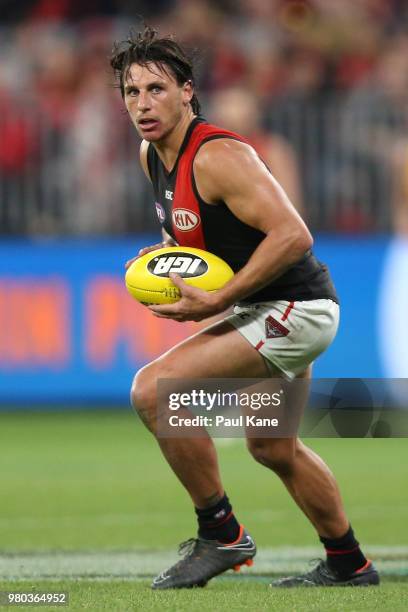 Mark Baguley of the Bombers looks to pass the ball during the round 14 AFL match between the West Coast Eagles and the Essendon Bombers at Optus...