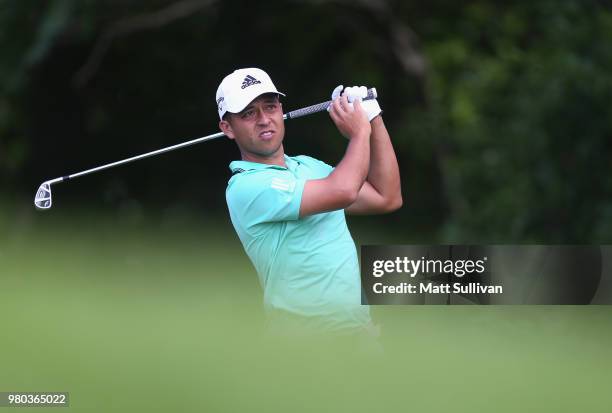 Xander Schauffele watches his tee shot on the 12th hole during the first round of the Travelers Championship at TPC River Highlands on June 21, 2018...