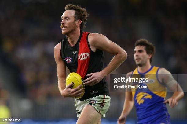 Mitch Brown of the Bombers looks to pass the ball during the round 14 AFL match between the West Coast Eagles and the Essendon Bombers at Optus...