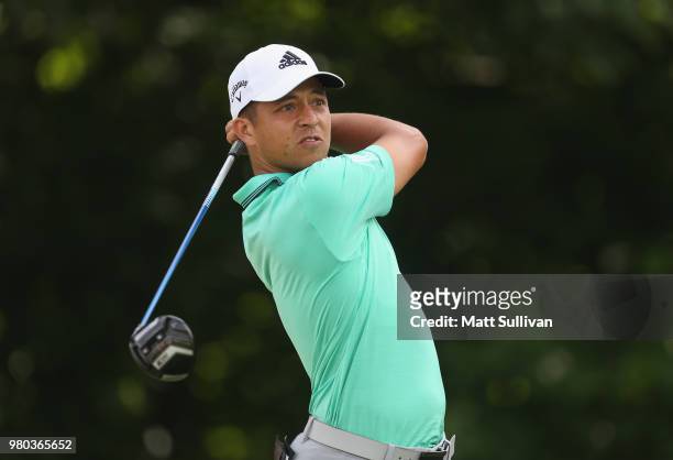 Xander Schauffele watches his tee shot on the 13th hole during the first round of the Travelers Championship at TPC River Highlands on June 21, 2018...