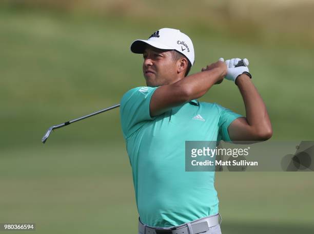 Xander Schauffele watches his second shot on the 12th hole during the first round of the Travelers Championship at TPC River Highlands on June 21,...