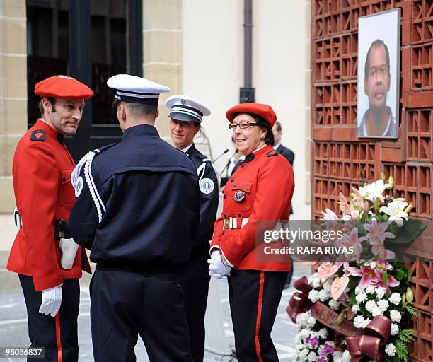 Basque and French policemen discuss after an homage ceremony to Serge Nerin, at the Basque regional parliament in Vitoria, northern Spain, on March...