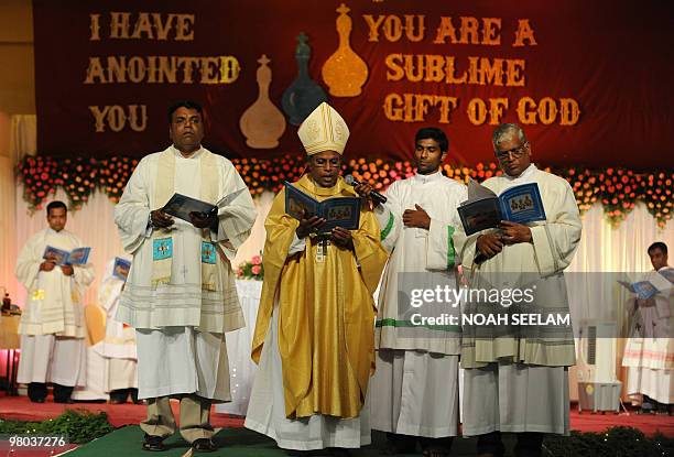 Indian Catholic Bishop of the ArchDioecese of Hyderabad Reverend M.Joji renews the vows of priests during the Chrism Mass at Saint Joseph's High...