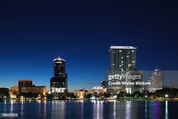 skyline from lake eola, evening - lake eola stock pictures, royalty-free photos & images