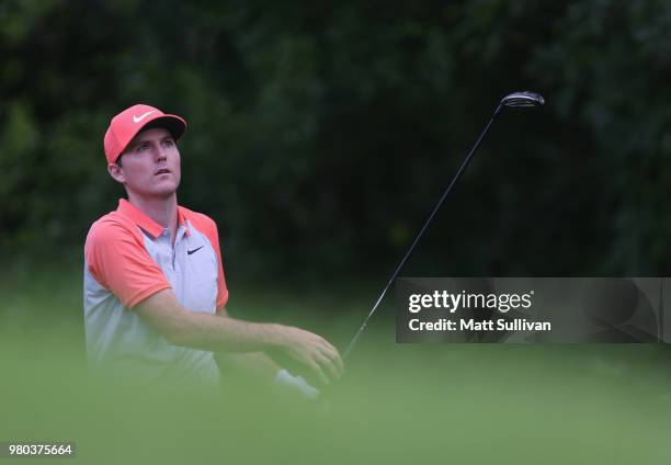 Russell Henley watches his tee shot on the 12th hole during the first round of the Travelers Championship at TPC River Highlands on June 21, 2018 in...