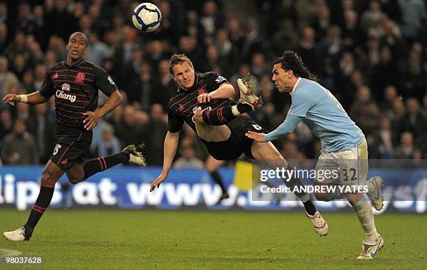 Everton's English defender Phil Jagielka vies with Manchester City's Argentinian forward Carlos Tevez during the English Premier League football...