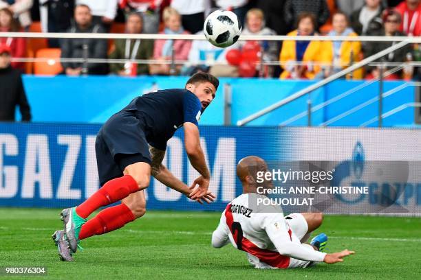France's forward Olivier Giroud gets to the ball ahead of Peru's defender Alberto Rodriguez leading up to the goal during the Russia 2018 World Cup...