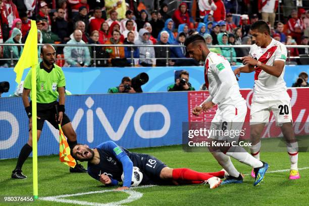 Nabil Fekir of France is fouled by Miguel Trauco and Edison Flores of Peru during the 2018 FIFA World Cup Russia group C match between France and...