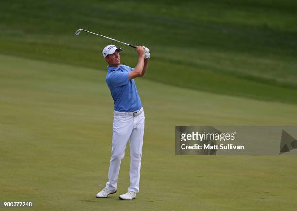 Webb Simpson watches his second shot on the 14th hole during the first round of the Travelers Championship at TPC River Highlands on June 21, 2018 in...