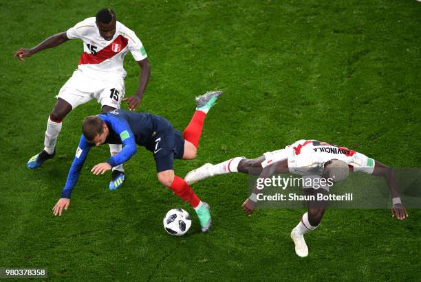 Antoine Griezmann of France is challenged by Christian Ramos of Peru and Luis Advincula of Peru during the 2018 FIFA World Cup Russia group C match...