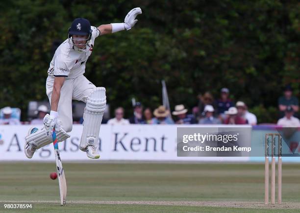 Joe Denly of Kent jumps to avoid the ball on day two of the Specsavers County Championship: Division Two match between Kent and Warwickshire at The...