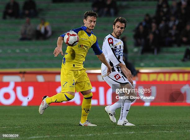 Santiago Morero of Chievo competes with Antonio Floro Flores of Udinese during the Serie A match between Udinese Calcio and AC Chievo Verona at...