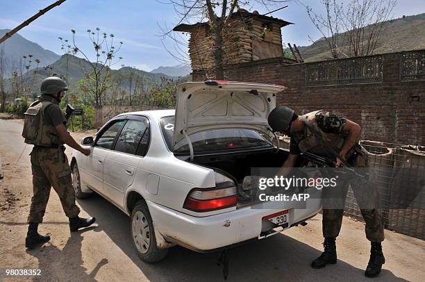 Pakistani soldiers check a car at a security checkpost on the outskirts of Mingora, the capital of Swat valley on March 25, 2010. The former tourist...