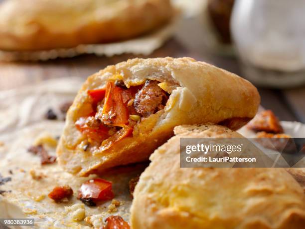 sausage and pepper calzone - pocket stock pictures, royalty-free photos & images