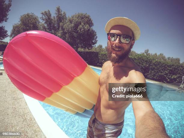 man falling in swimming pool with air mattress - straw hat stock pictures, royalty-free photos & images