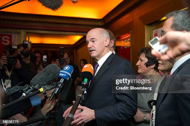 George Papandreou, Greece's prime minister, center, speaks to the media ahead of the European Socialist Party meeting in Brussels, Belgium, on...